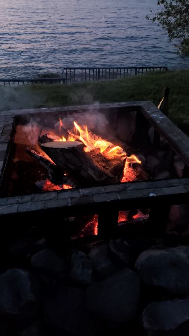 A picture of the campfire on the banks of the lake